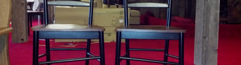 two ladderback chairs with crooked rungs