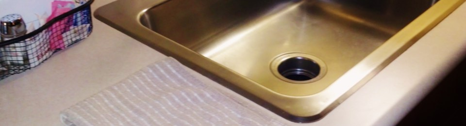 dishtowel on counter by sink