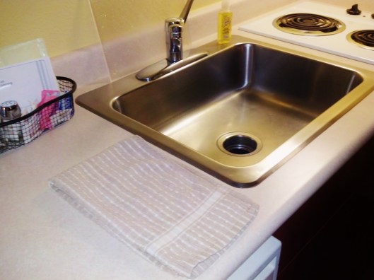 dishtowel on counter by sink