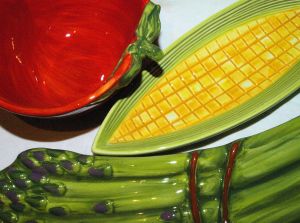 closeup of corn, tomato and asparagas shaped dishes