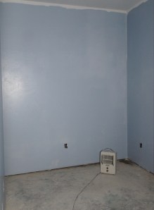 corner of room under construction with space heater occuping it.