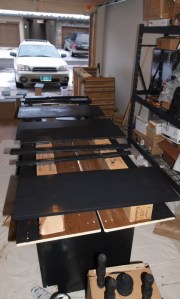 lined up furniture parts being painted