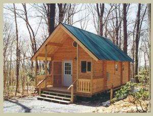 small rectangular log cabin with roof and front porch