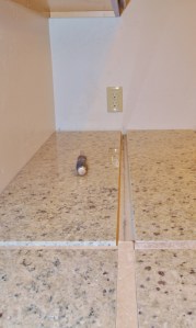 slabe of granite on a countertip with a small cross pattern between the slabs