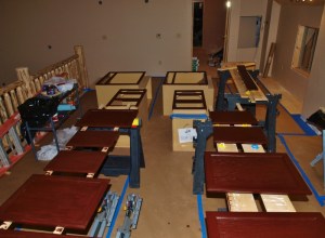 row of saw horses with cabinet doors and drawers and the casegoods boxes all being stained