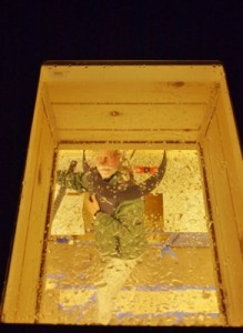 view through skylight into kitchen where man is playing up to the camera
