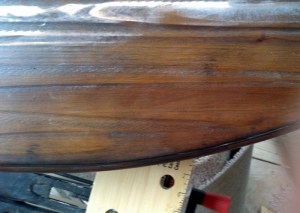 closeup of table top showing hand-scraped texture with distressed finish