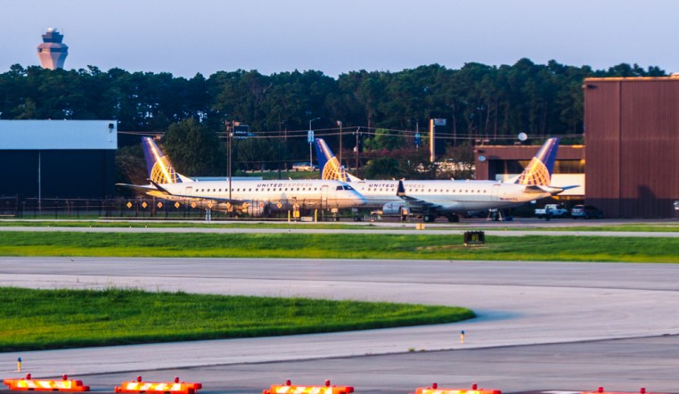 planes parked nose to tail.